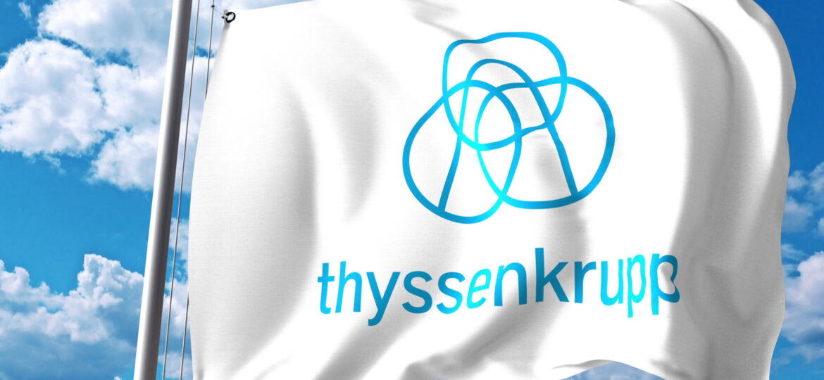 Waving flag with ThyssenKrupp logo against clouds and sky.